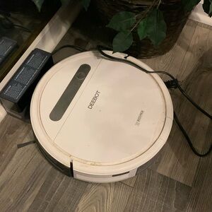White Ecovacs robotic vaccum and mop.